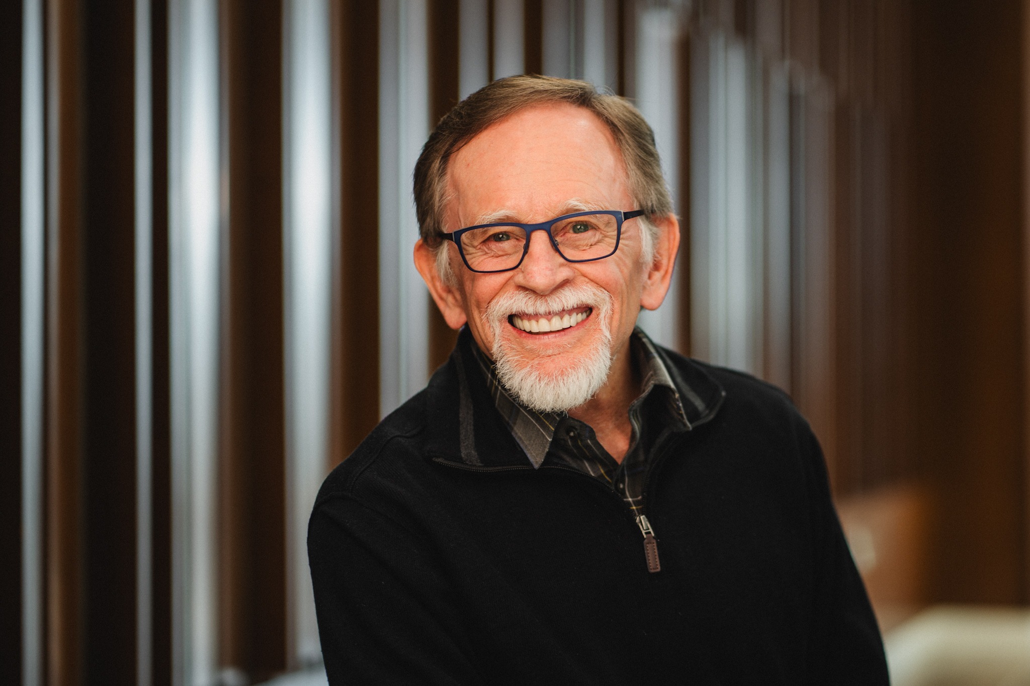 Professor Randy Dryer, an older man with greying hair, a silver goatee, and black glasses