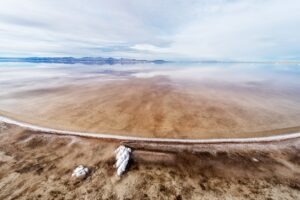 Exposed sandy bottom of Great Salt Lake with large salt crystals
