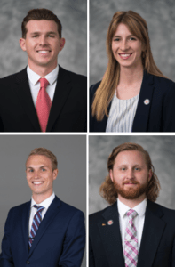 Nate Gardner (a young white man with dark brown hair), Molly Hemenway (a young white woman with long. blonde hair), Nicholas Sauer (a young man with short blonde hair), and Anthony Tenney (a young man with shoulder-length red hair and a beard)