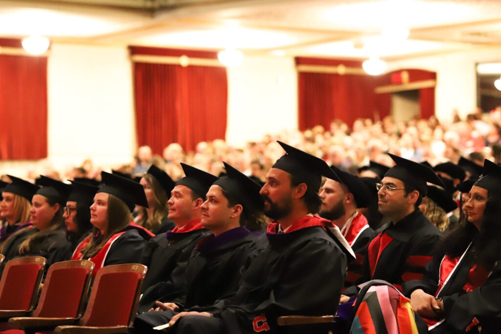 S.J. Quinney College of Law 2023 graduates sit in Kingsbury Hall during convocation ceremony